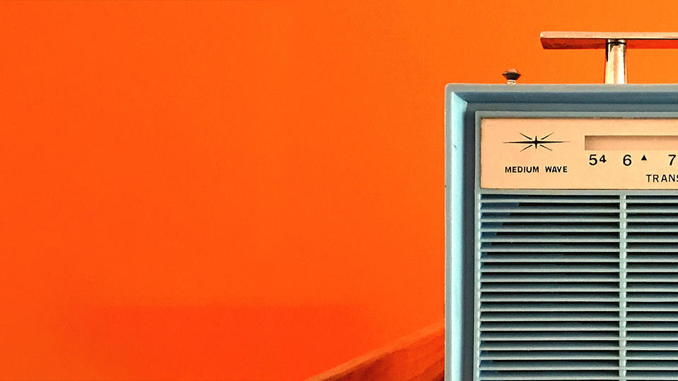 Vintage radio on an orange background