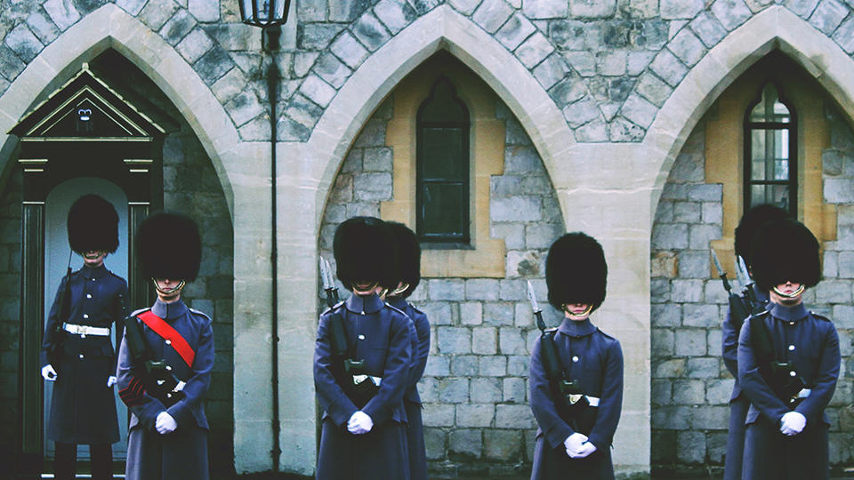 Guards standing outside of a stone building