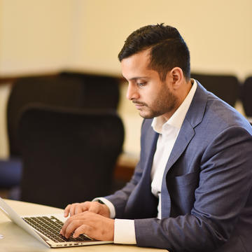 Man in suit working on computer