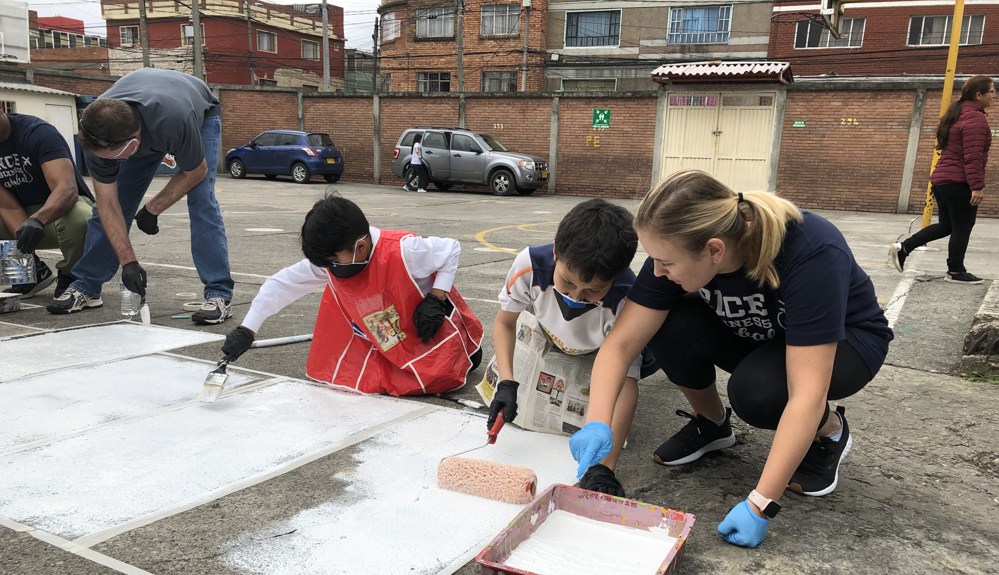 Student painting with children