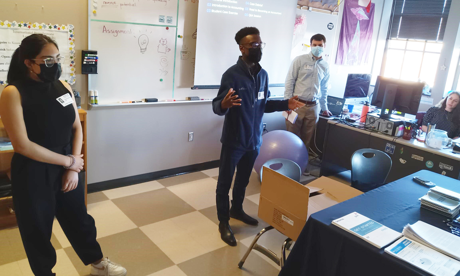 MAcc students speaking in front of a class