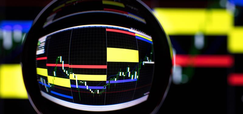 Crystal ball in front of computer screen with graph