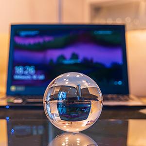 Cyrstal ball in front of laptop