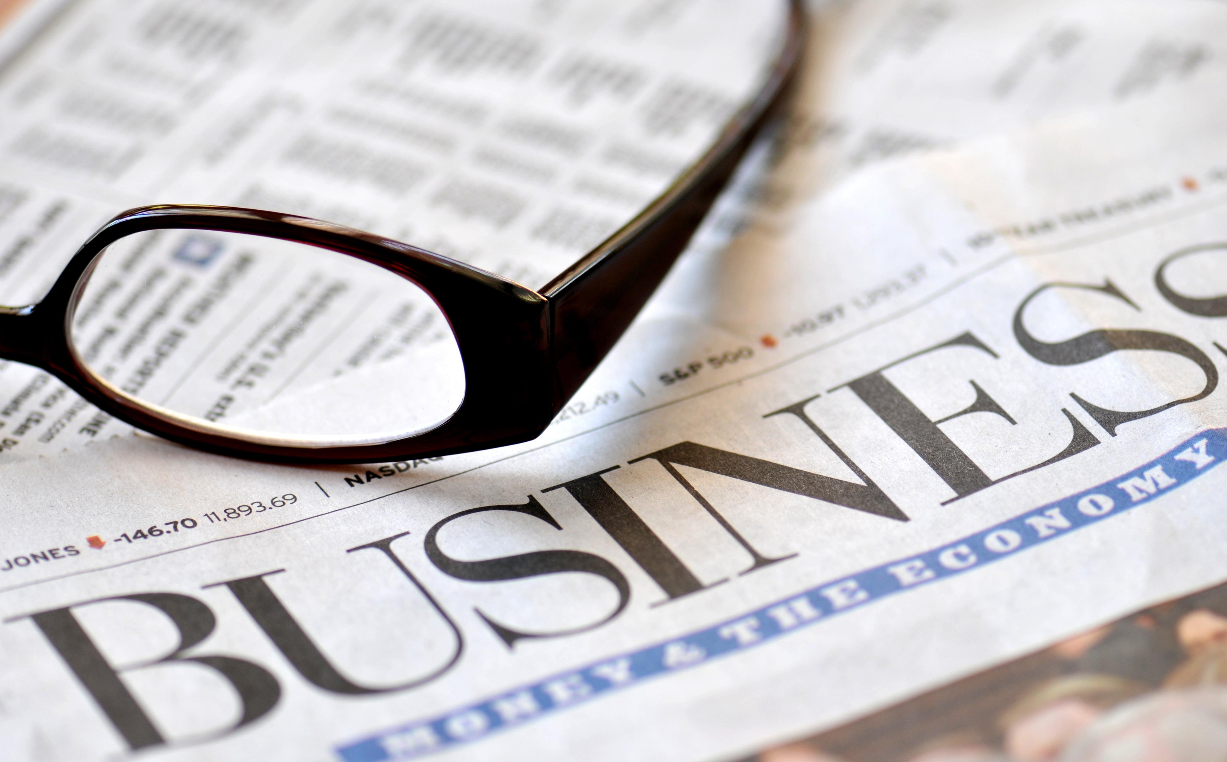 Business newspaper with eyeglasses
