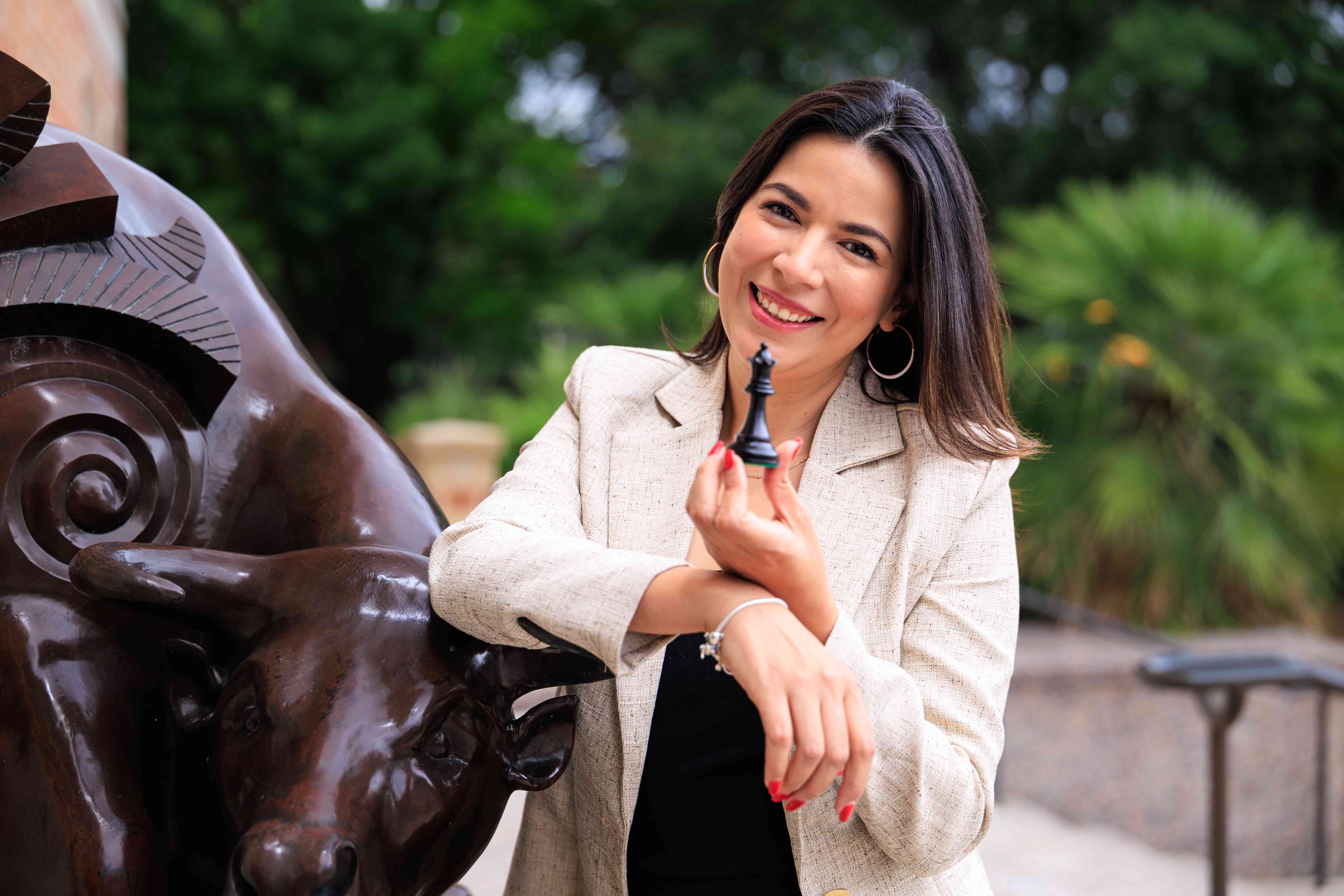 Marcela Aguilar holding a black queen chess piece