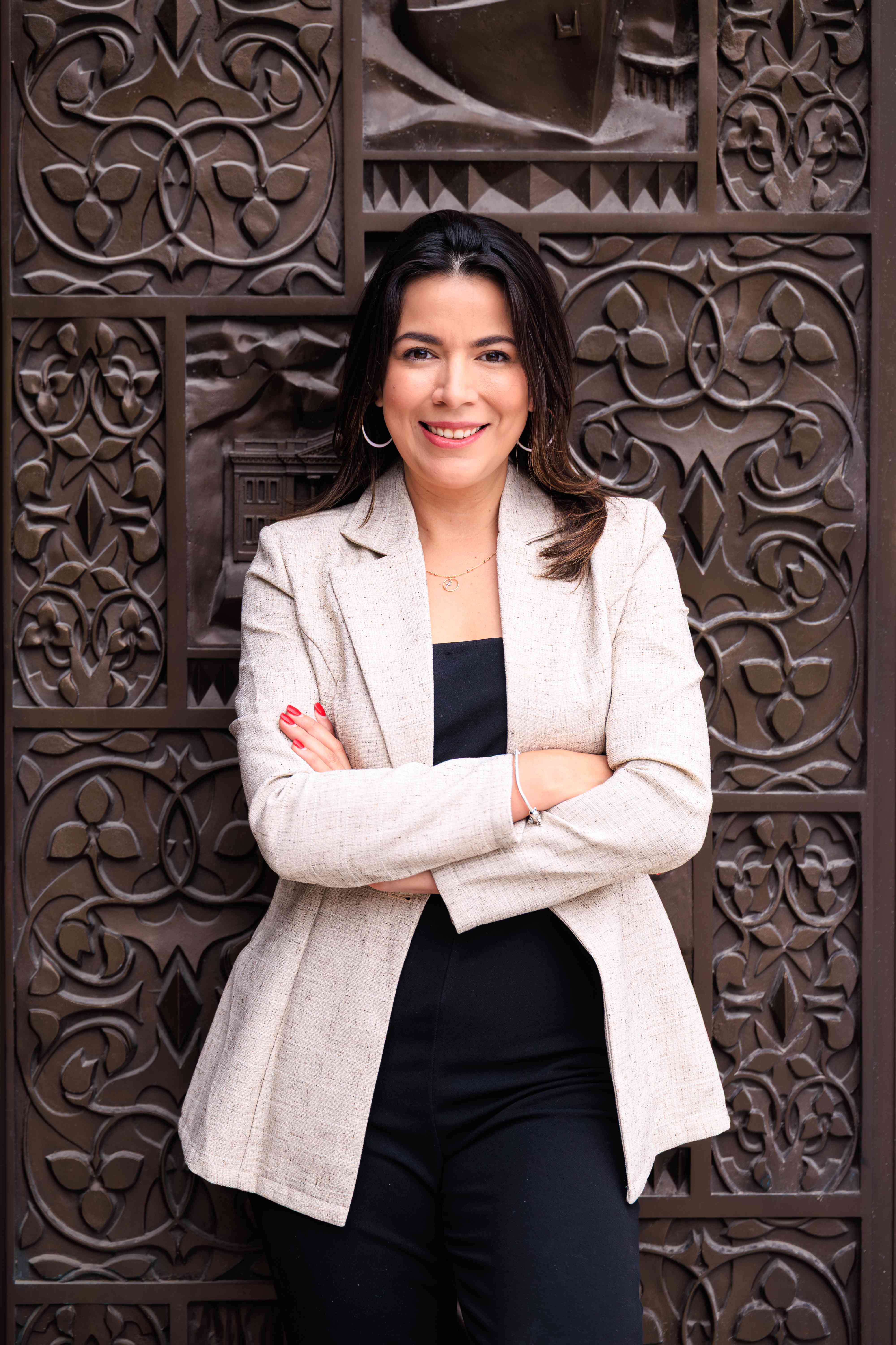 Marcela Aguilar in front of McNair Hall door