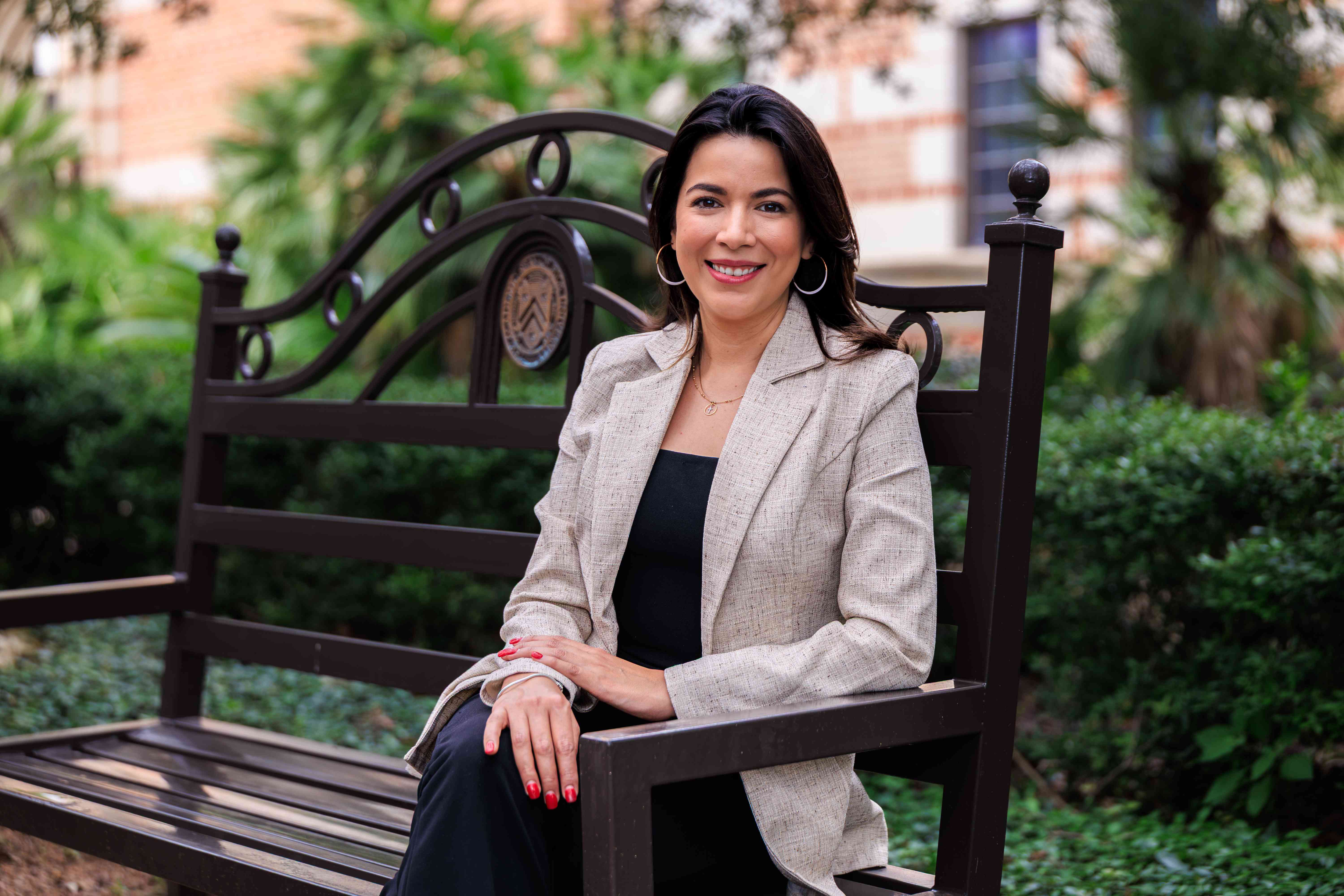 Marcela Aguilar sitting on bench outside of McNair Hall