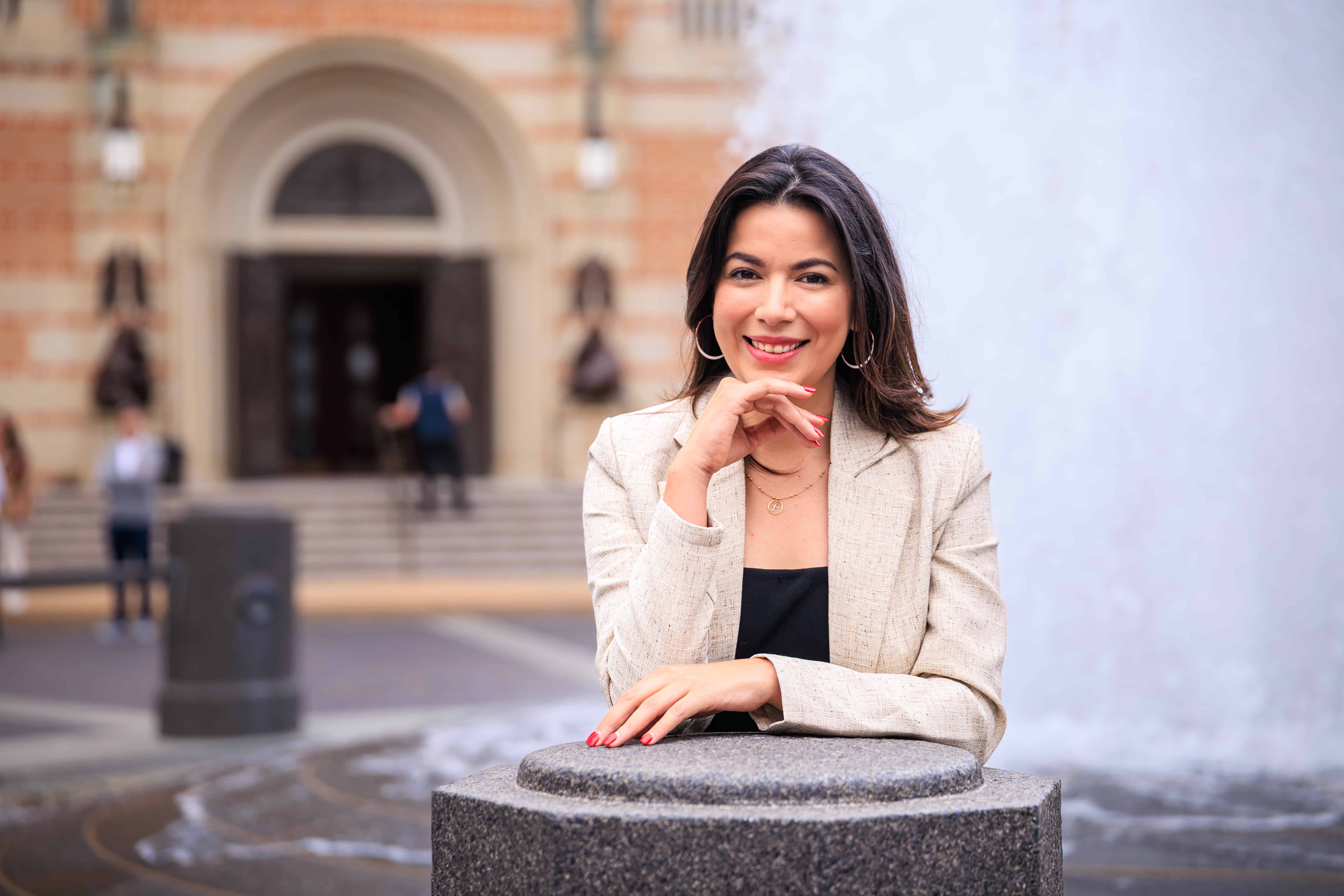 Marcela Aguilar standing in front of fountain.