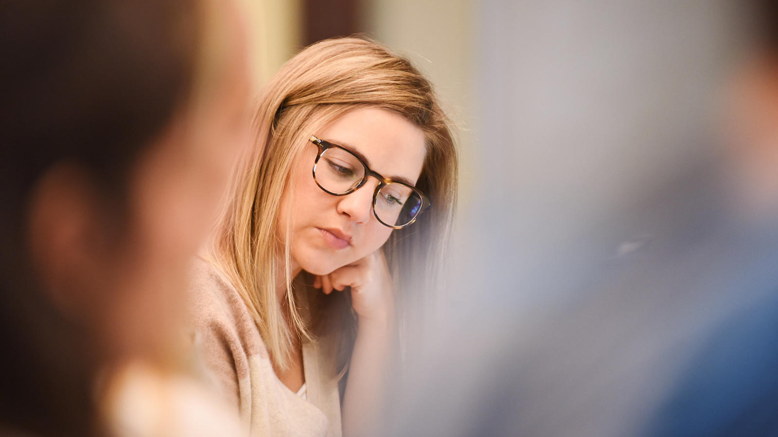 Female student with glasses thinking