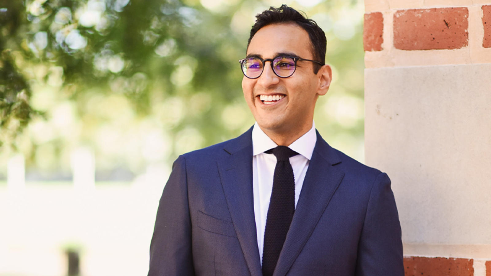 Kunal Sachdeva profile standing in suit
