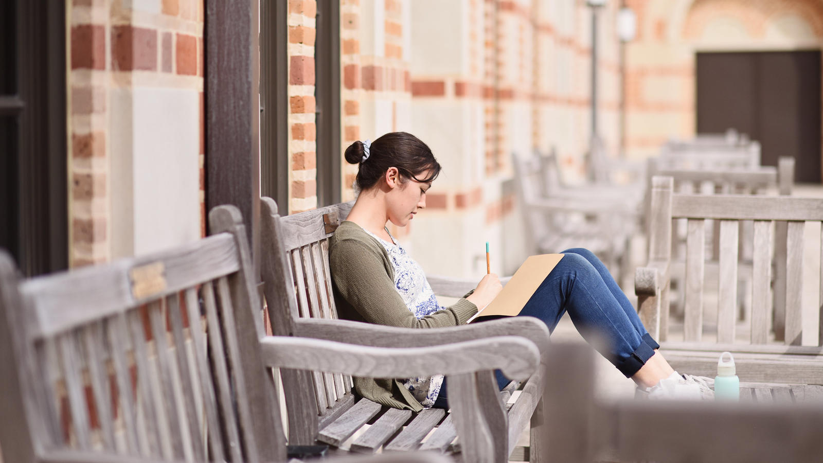 Girl sitting on outside benches