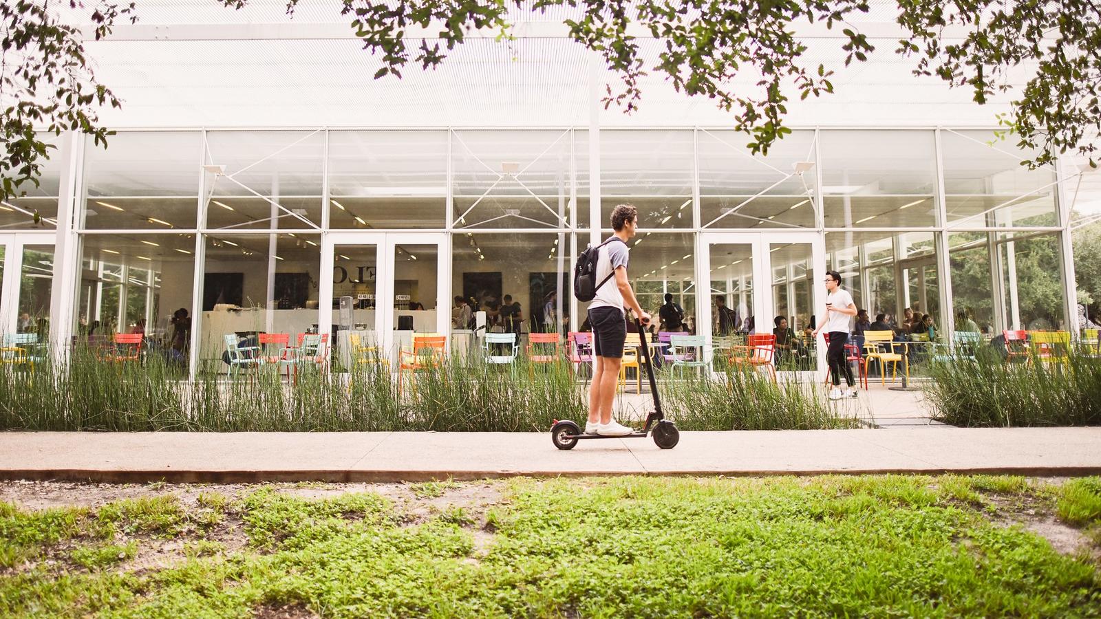 Student riding on scooter
