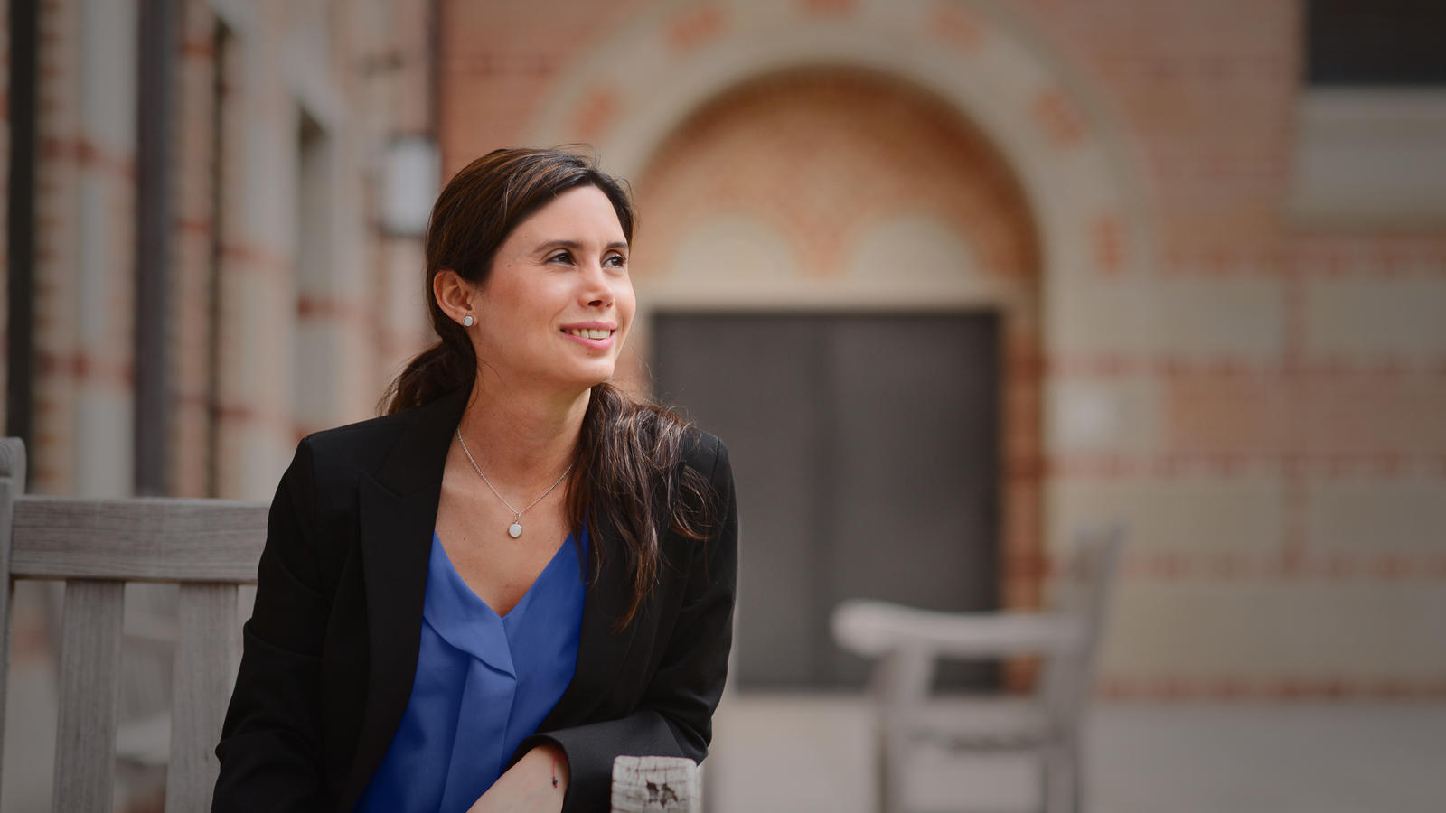 Woman In Blue Shirt In Courtyard