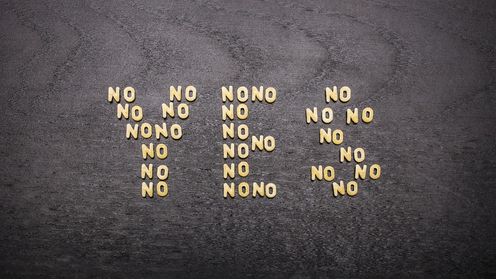 Yes sign made up of little nos