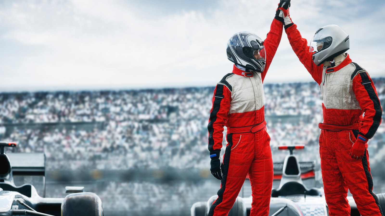 Race car drivers high five.