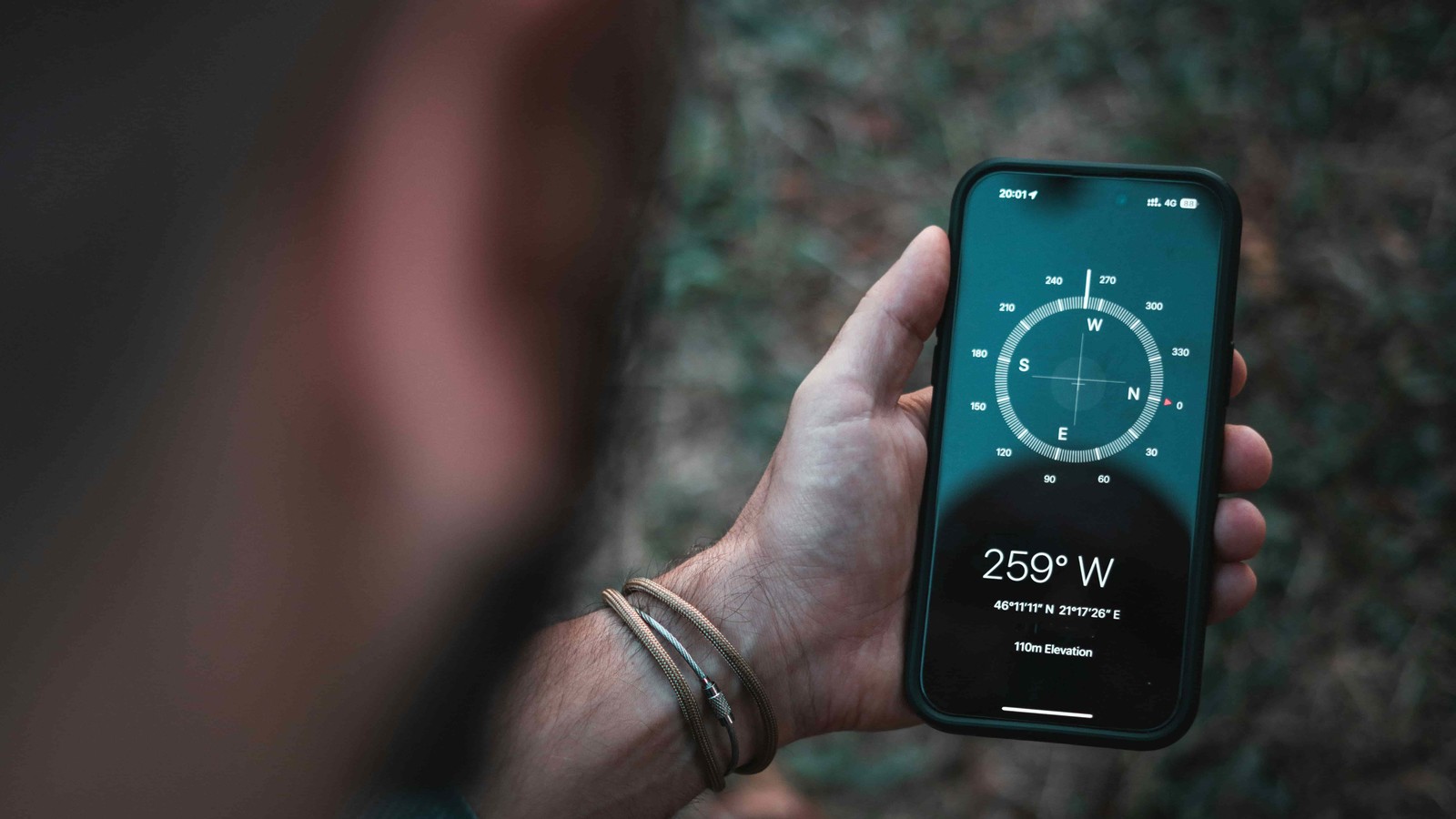 Man looks at compass app on his phone