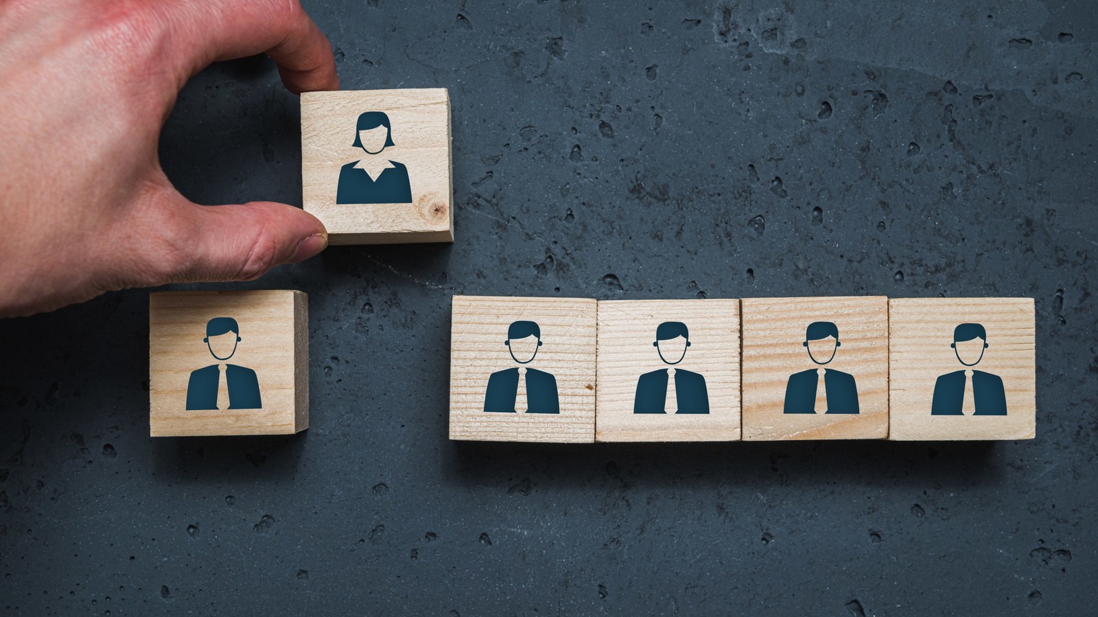 Line of blocks with men icons with a woman icon block removed