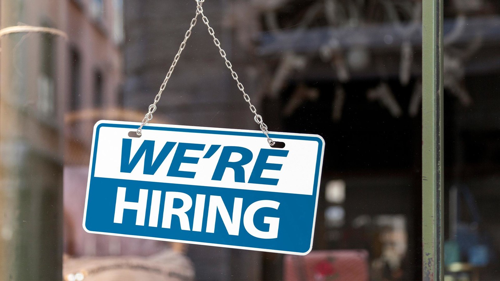 Window sign says we're hiring