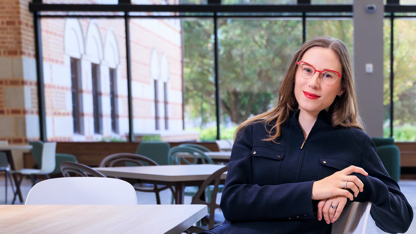 Emily Prinsloo sitting at table in Virani Hall