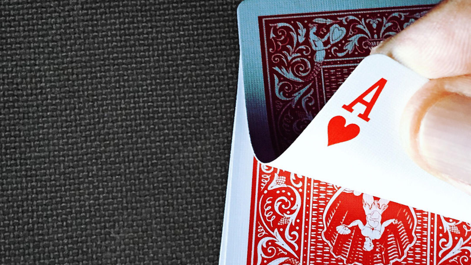 Flipping over a playing card to reveal the ace of hearts