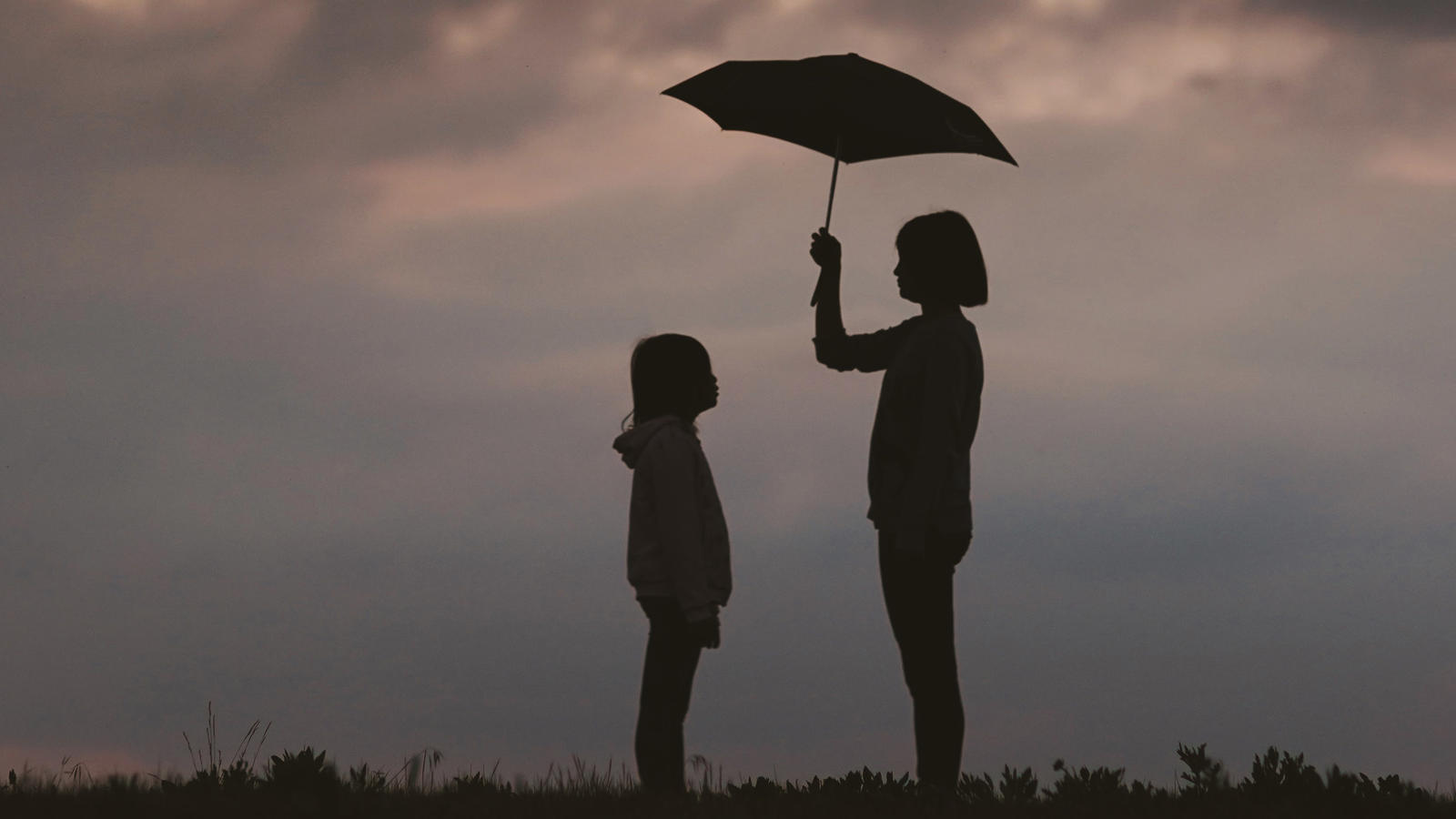 Two people under an umbrella