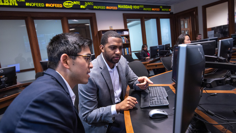 Two men looking at computer screen