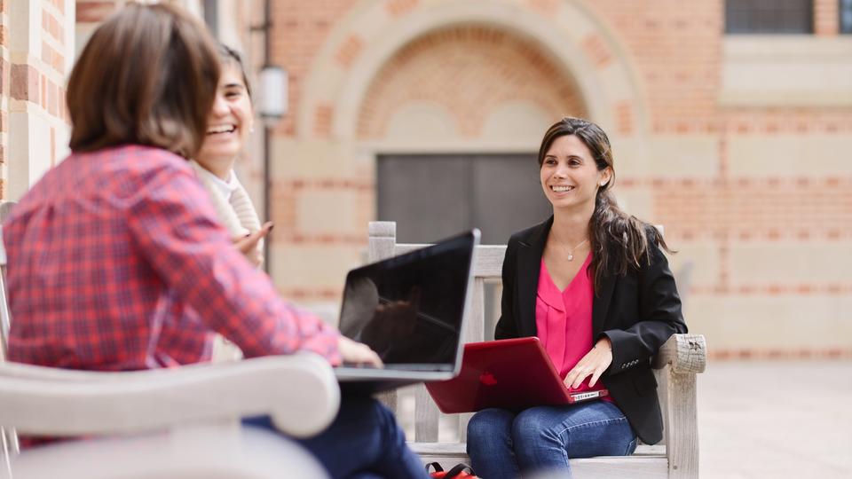 Rice Business Ph.D. female students working outside on laptops