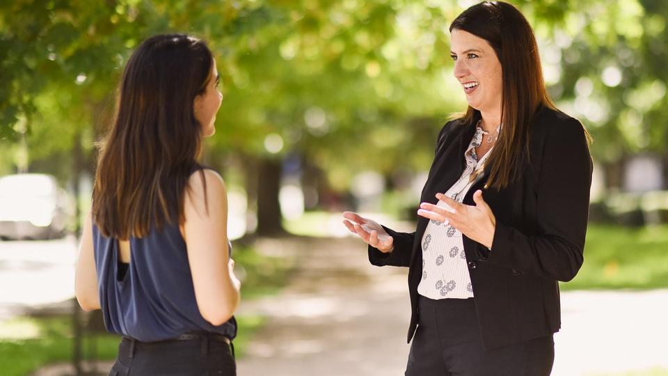 Professor speaking with student outdoors