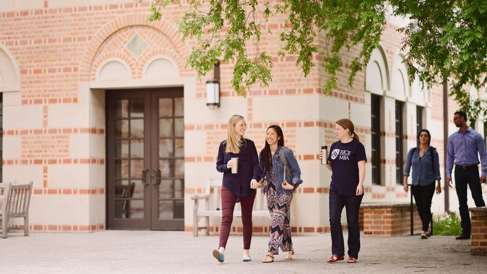 Three female students walking outdoors