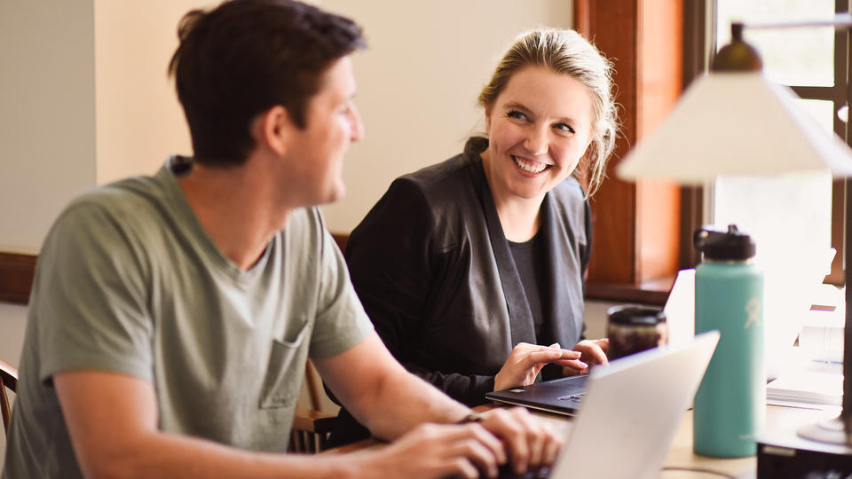 Male and female mba students working together