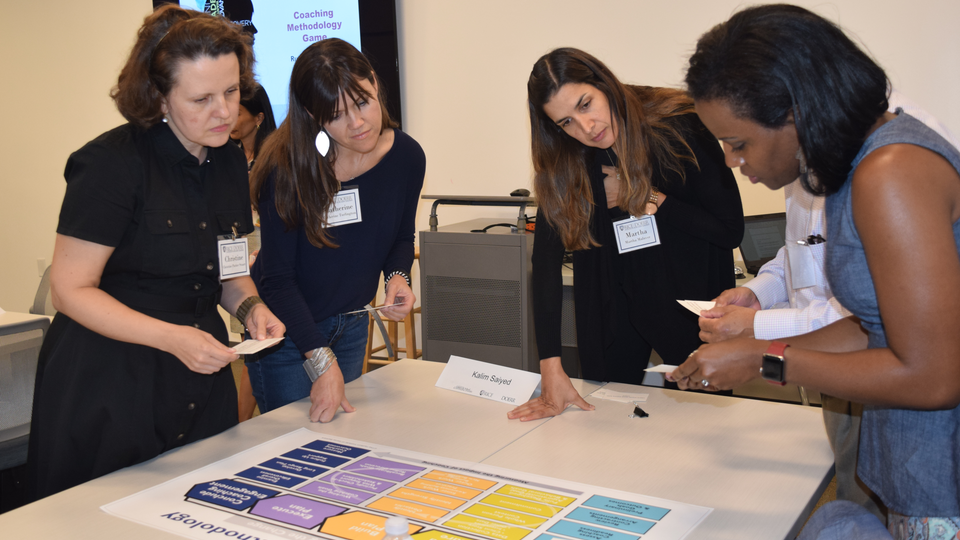 Women working on project together at coach rice