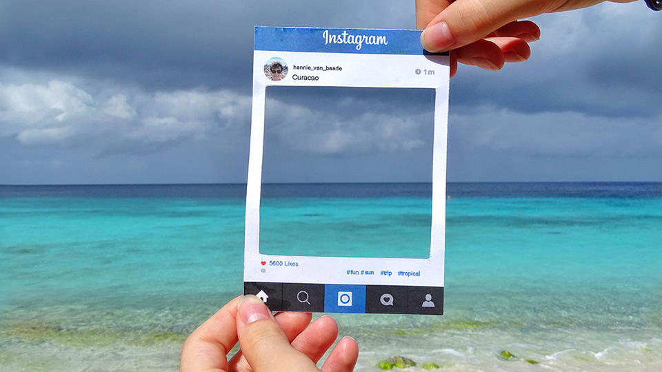 Person holding up a picture frame