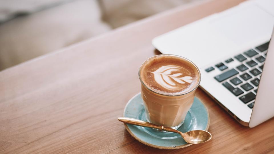 Coffee next to laptop