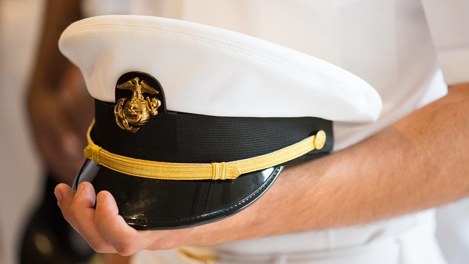 U.S. Navy officer holding his cap