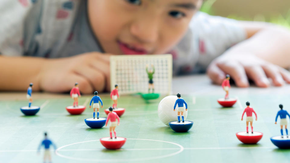 Boy playing table soccer