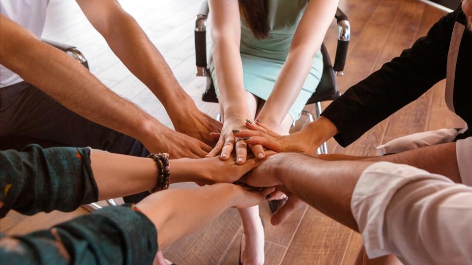 Business people folding their hands together
