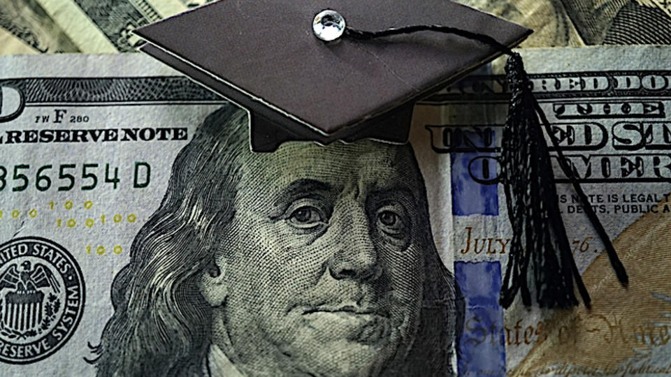 Dollar bill with graduation cap