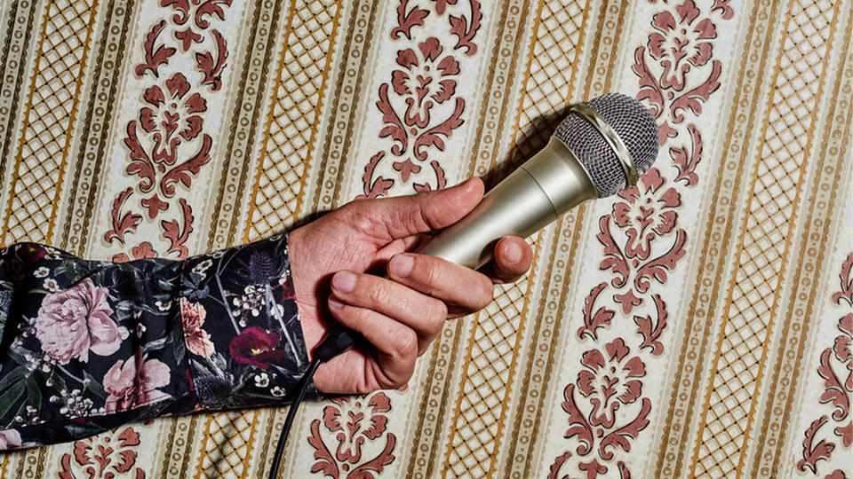 Hand holding microphone