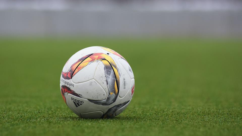 Close-up of a soccer ball in a green field