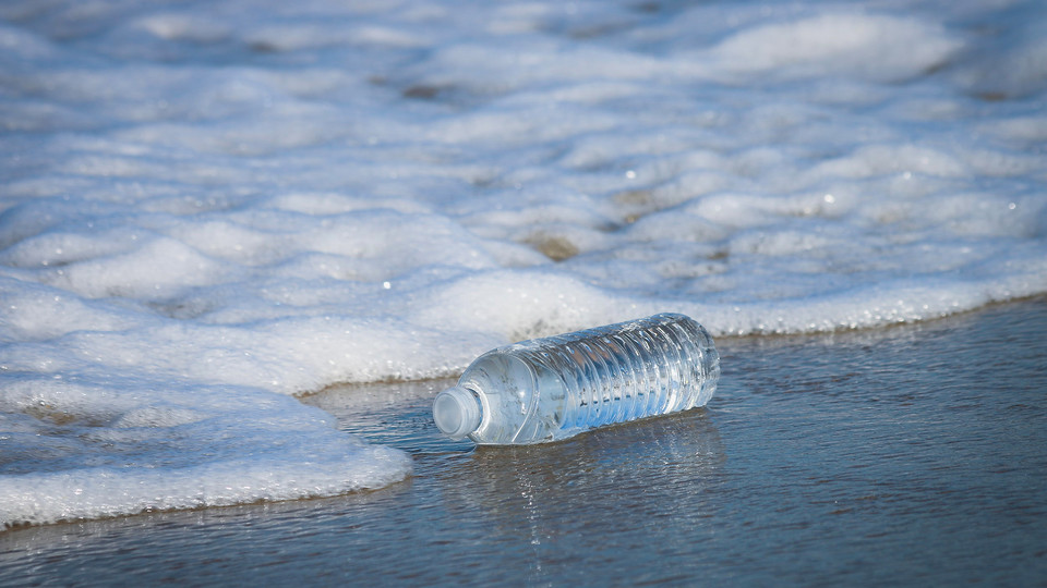 Plastic water bottle sitting on the beach