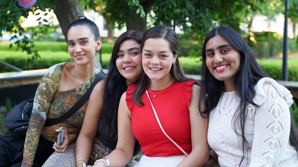 Female student standing with her colleagues, smiling