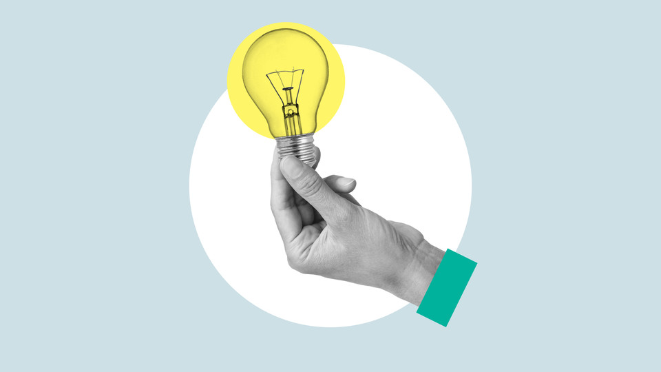 Hand holding lightbulb