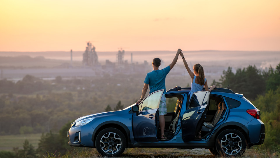 Two people in a car overlooking a city