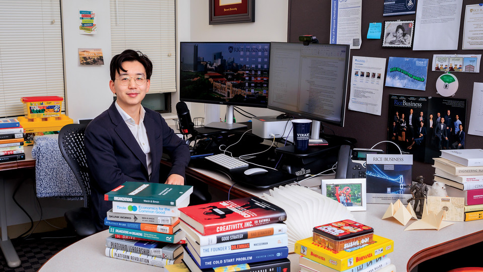 Tommy Pan Fang sitting at a computer in his office.