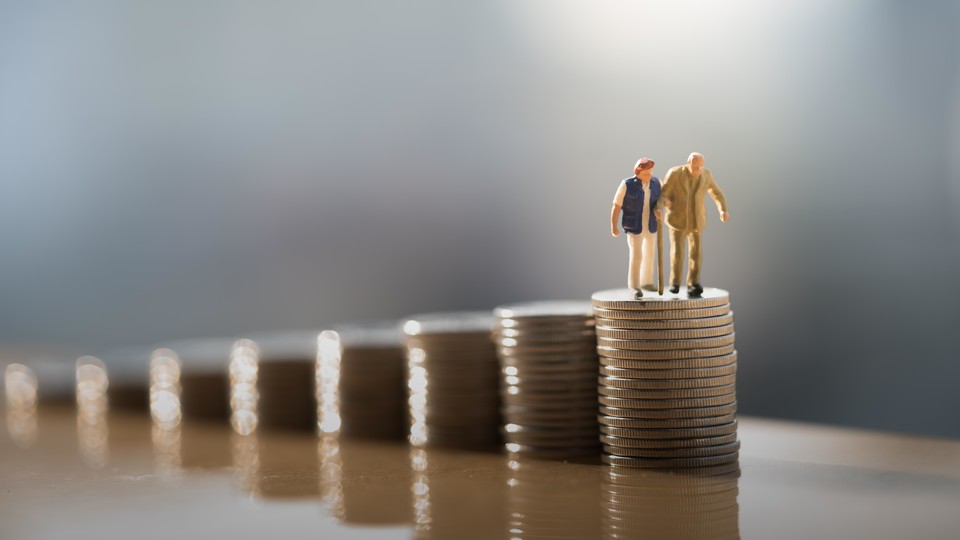 Figurines of older couple on stack of coins