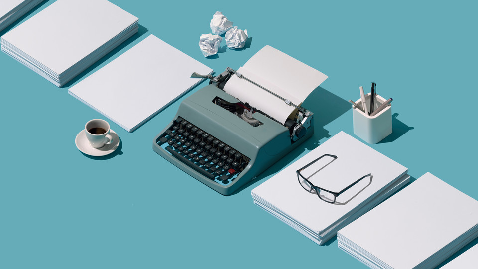Typewriter and piles of paper