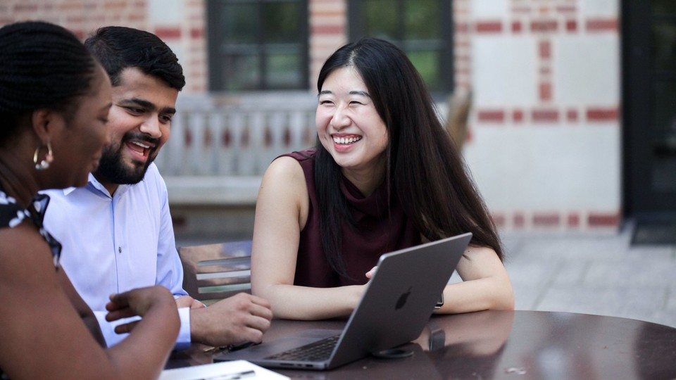 MBA students sitting outside McNair Hall