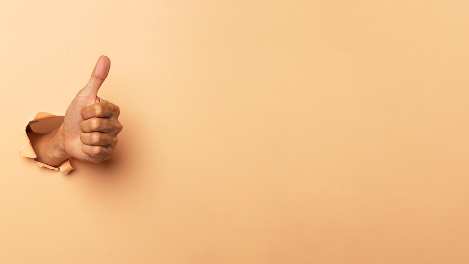 Thumbs-up hand punches through wall
