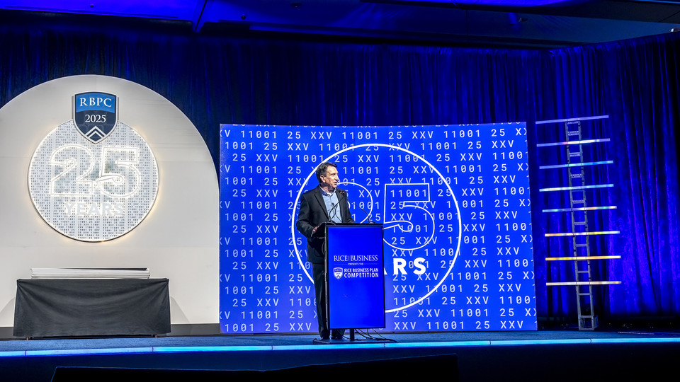 Brad Burke standing on stage at the Rice Business Plan Competition