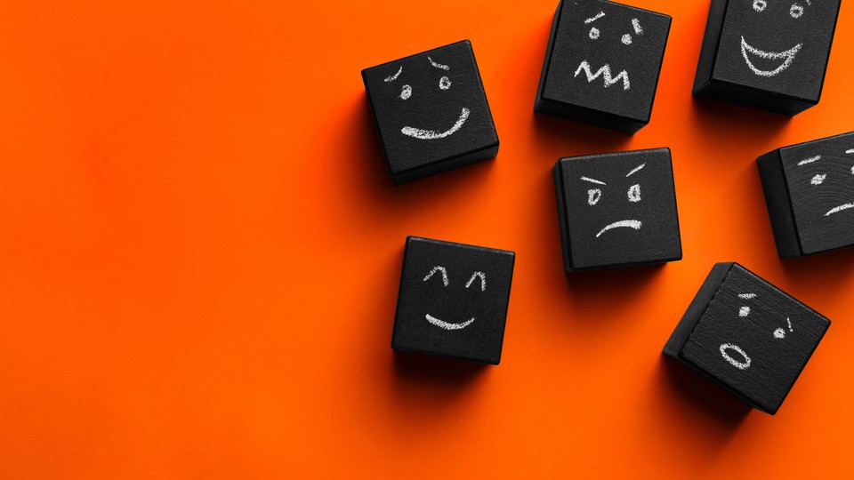 Orange background with black blocks that have a variety of hand-drawn emotive faces.